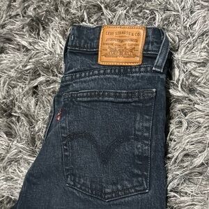 Levi Wedgie denim. 99 percent cotton. Real leather patch. Washed black color.